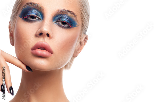 Beautiful blonde girl with full lips and bright stylish makeup