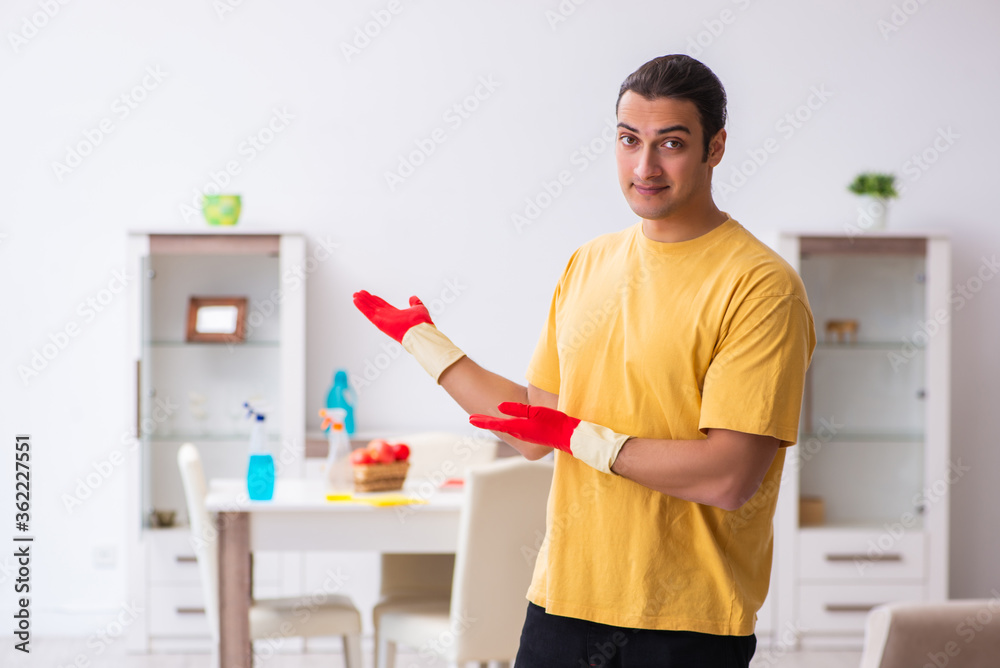 Young male contractor cleaning the house Young male contractor cleaning the house