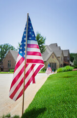 American flags displayed on the side of the street in honor of the 4th of July in a Texas neighborhood