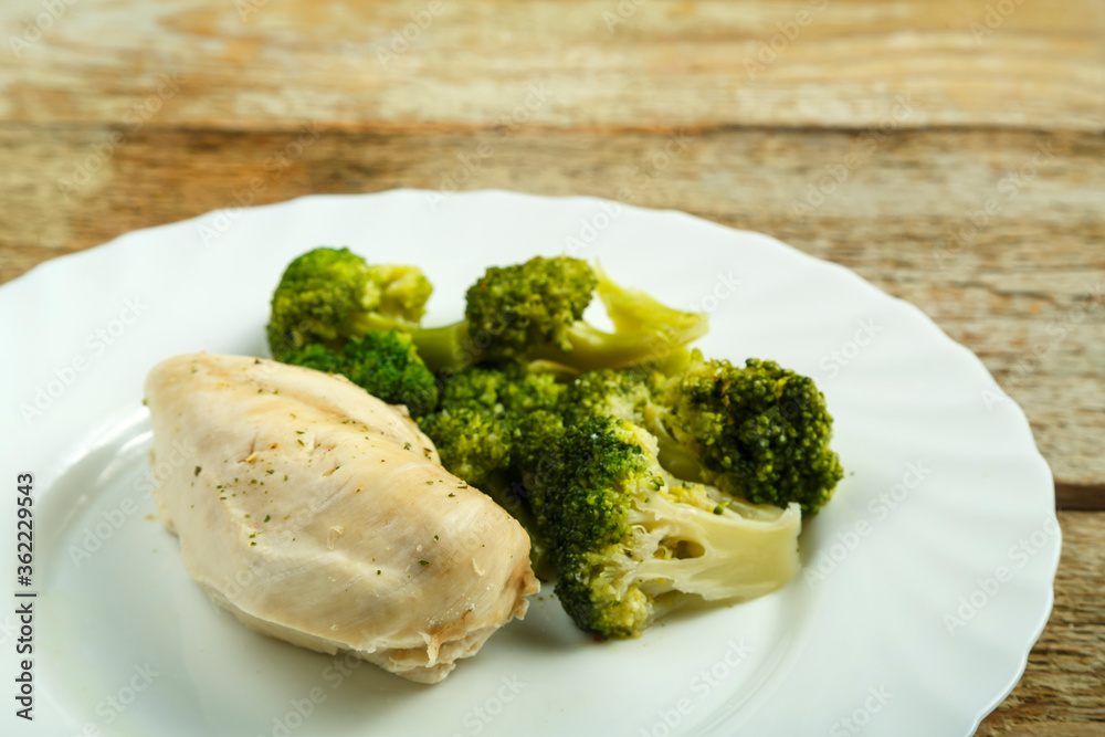 boiled broccoli and chicken breast without salt on a plate. boiled broccoli and chicken breast without salt on a plate.