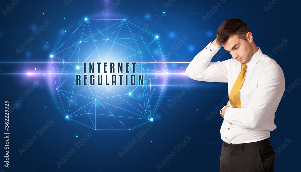 Businessman thinking about security solutions with INTERNET REGULATION inscription