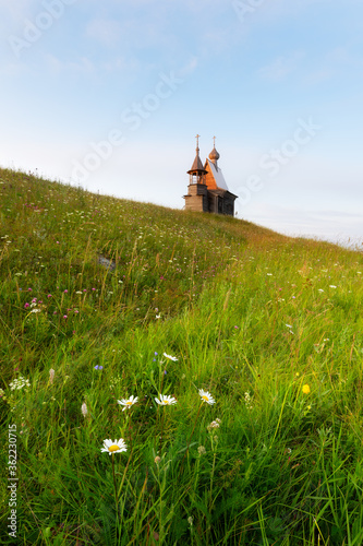 Medieval wooden temple of Nicolas on a hill in the Vershinino village.Kenozersky National Park. photo