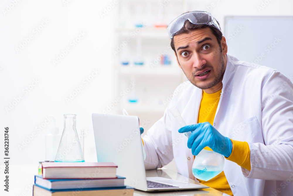 Young male chemist student preparing for exam Young male chemist student preparing for exam