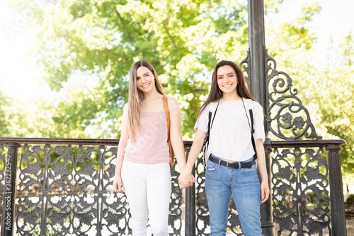 Smiling Friends Holding Hands at a park © AntonioDiaz