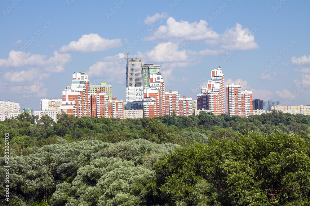 Panoramic view of modern residential buildings in Moscow Russia on a clear Sunny summer day with green trees a copy space