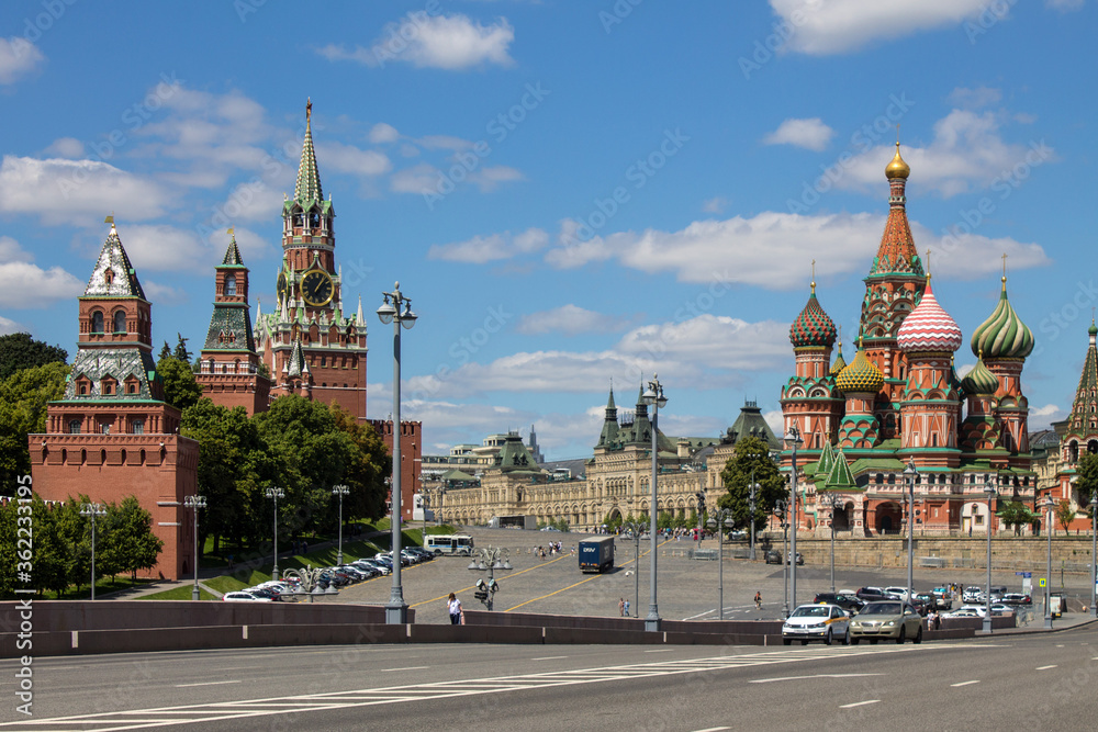 Panoramic view of Red square in Moscow with St. Basil's Cathedral and the Kremlin on a clear summer day against a blue sky and space to copy