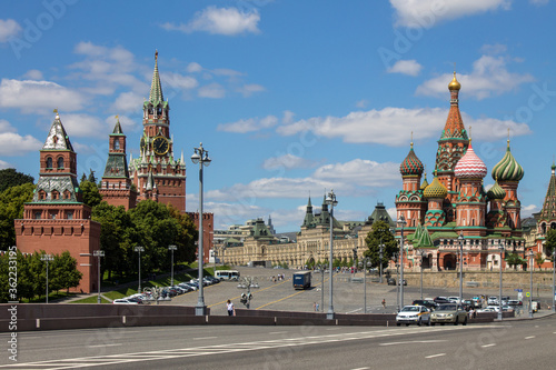 Panoramic view of Red square in Moscow with St. Basil's Cathedral and the Kremlin on a clear summer day against a blue sky and space to copy