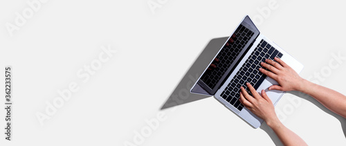 Person using a laptop computer from above photo