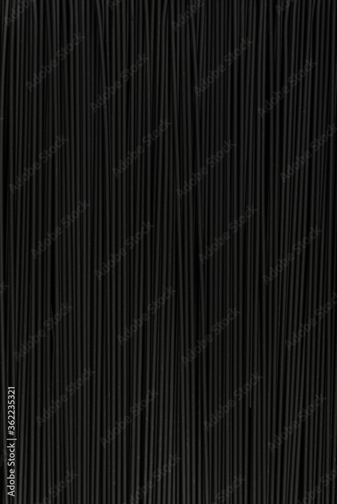 Obraz premium Black textured surface. Abstract black background. Spaghetti. Vertical frame