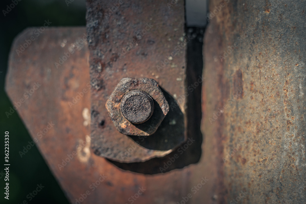 Close-up image of old rusty steel bolt with blurred background