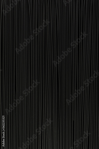Black textured surface. Abstract black background. Spaghetti. Vertical frame