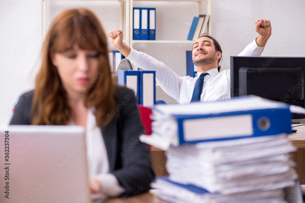 Two employees working in the office Two employees working in the office