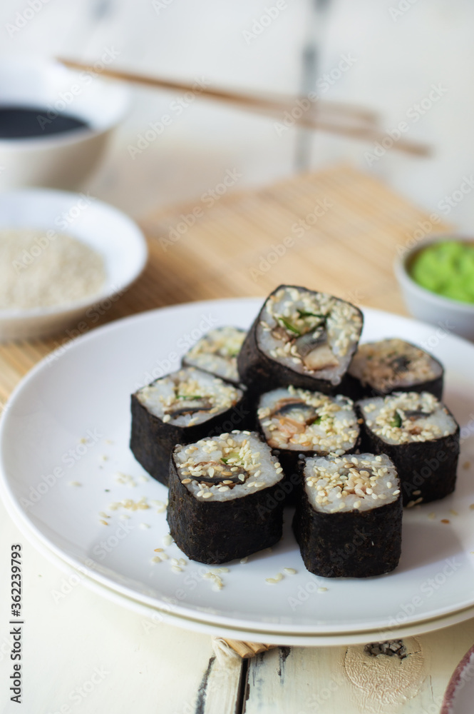 Sushi rolls with eel, sesame, cucumber and wasabi Sushi rolls with eel, sesame, cucumber and wasabi
