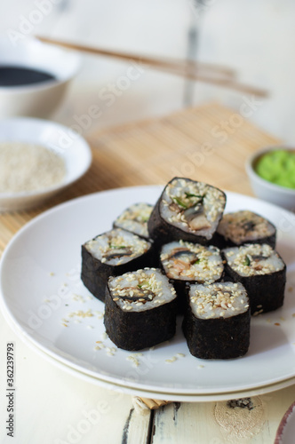 Sushi rolls with eel, sesame, cucumber and wasabi 