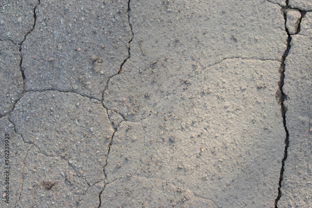 Obraz premium Old asphalt with cracks, gray background