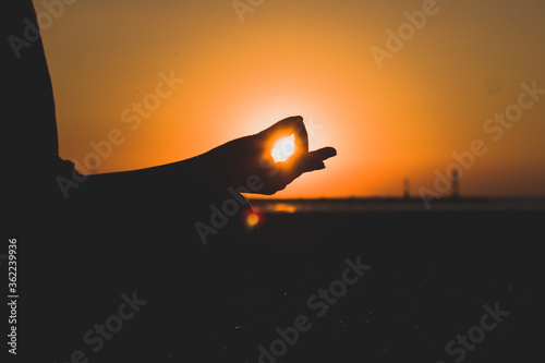 woman catching the sun doing yoga