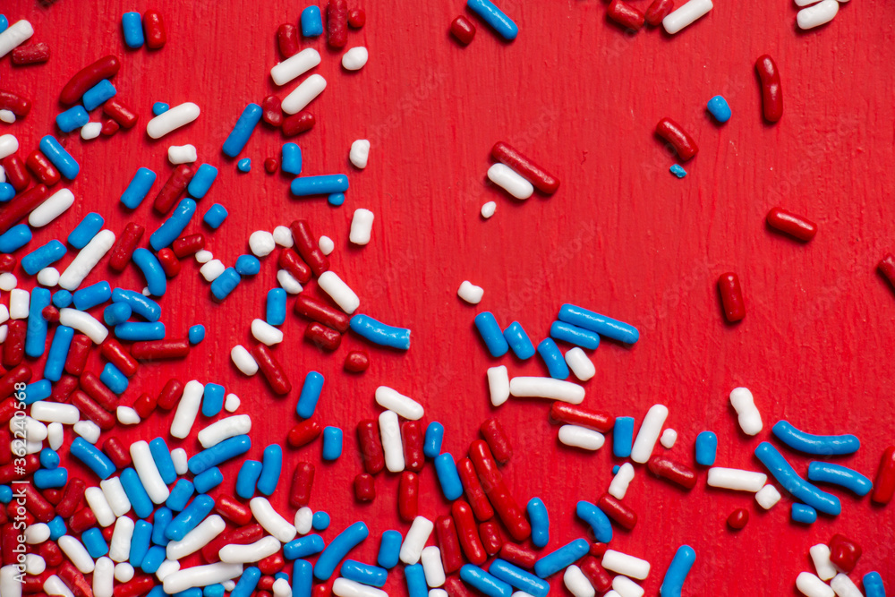 Red, White, and Blue Sprinkles on Red Background Red, White, and Blue Sprinkles on Red Background
