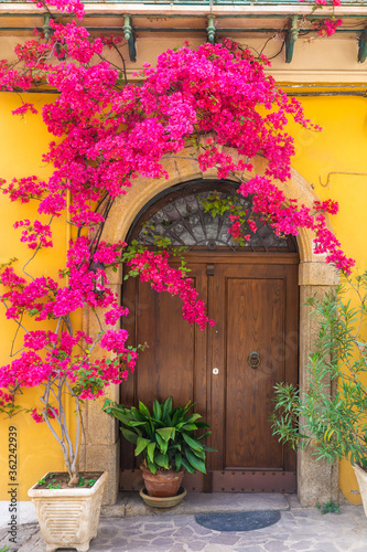 Fototapeta Naklejka Na Ścianę i Meble -  Italian house exterior with bougainvillea flowers on the wall in town Positano, Amalfi coast, Campania, Italy