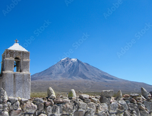 Church in Tacora and volcano of the same name in the Highlands (Altiplano) of Chile. photo