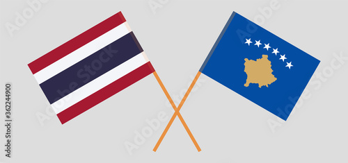 Crossed flags of Kosovo and Thailand photo