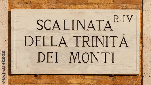 'Scalinata di Trinità dei Monti' (Spanish Steps) old traditional road sign on a brick wall, one of the most famous tourist site in Rome photo