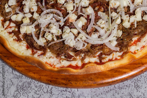 dried meat pizza with onion and heart of palm typical of Brazil where it is called Pizza de carne seca acebolada com palmito photo