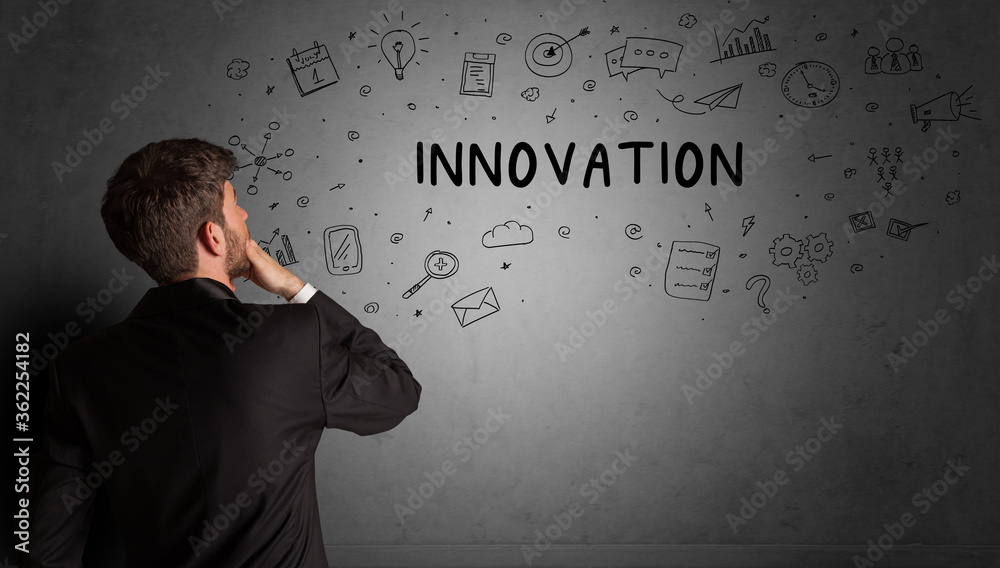 businessman drawing a creative idea sketch with INNOVATION inscription, business strategy concept businessman drawing a creative idea sketch with INNOVATION inscription, business strategy concept