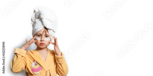 Fototapeta Naklejka Na Ścianę i Meble -  Cute girl in a yellow bathrobe with eye patches