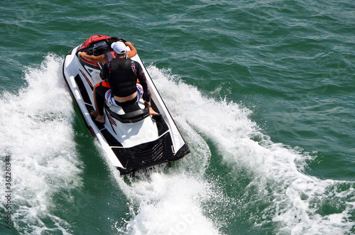 Angled overhead view of jet skiers riding tandem