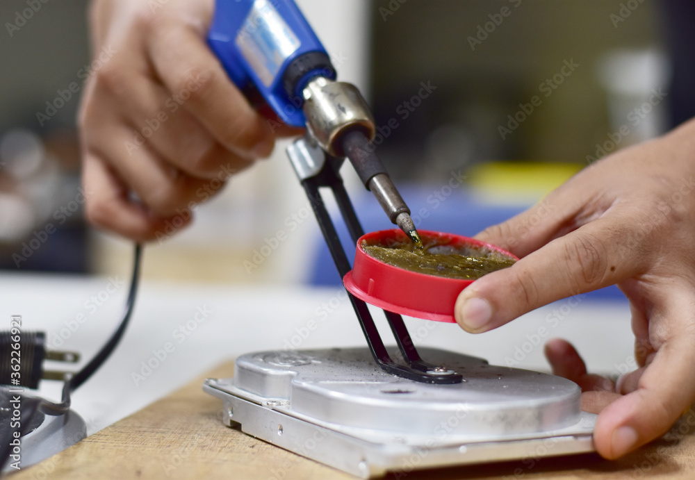 Computer maintenance technician repairing Electronic equipment and computer components, Selective focus. Computer maintenance technician repairing Electronic equipment and computer components, Selective focus.