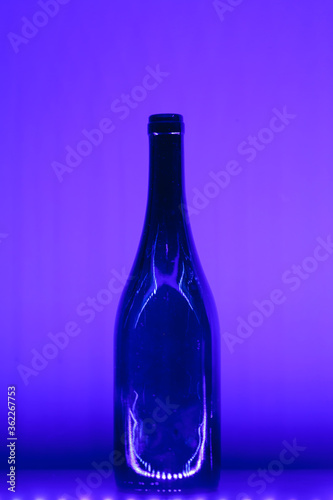 abstract empty wine bottle with violet led illumination