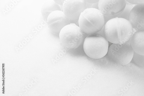 many snowballs on white snow background with copy-space