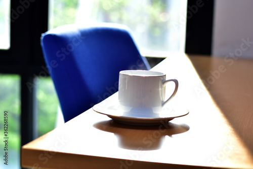 Cup of coffee ,smartphone and notebook on a wooden table. Simple workspace or coffee break in the morning.