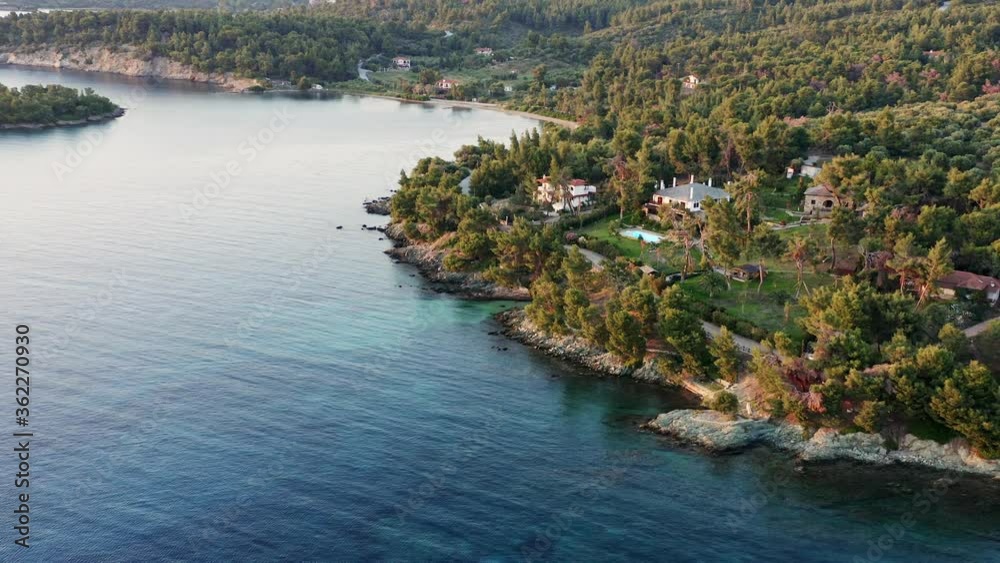Aerial shot of coastline with summer villa by the sea at sunset. Chalkidiki, Greece. Aerial shot of coastline with summer villa by the sea at sunset. Chalkidiki, Greece.