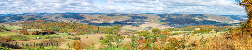 Fall maple trees and panorama of farm house land rolling hills aerial above high angle view landscape in Blue Grass, Highland County, Virginia