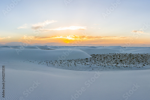 White sands dunes national monument park colorful view in New Mexico with horizon at sunset with silhouette of Organ Mountains