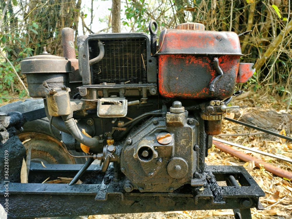 Dirty oil stains on old walking tractor or plows machine. Oil stains contaminate the engine, making it look dirty.