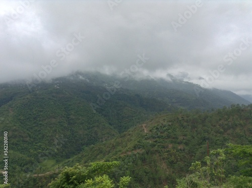 green hill with beautiful cloudy sky at morning time