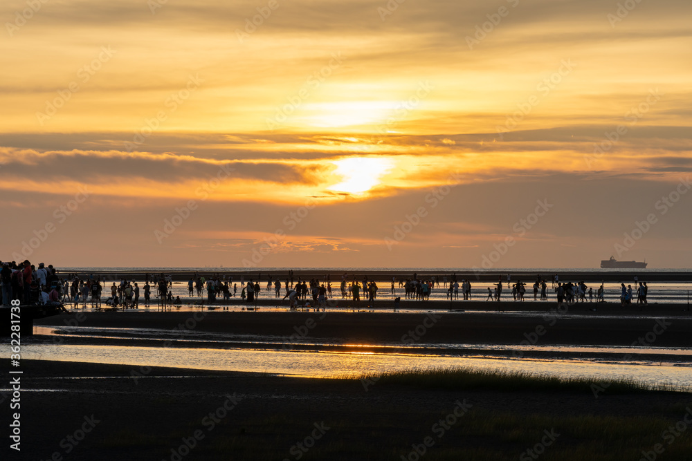 Crowded people playing the water in Gaomei Wetlands during sunset time. Qingshui District, Taichung City, Taiwan
