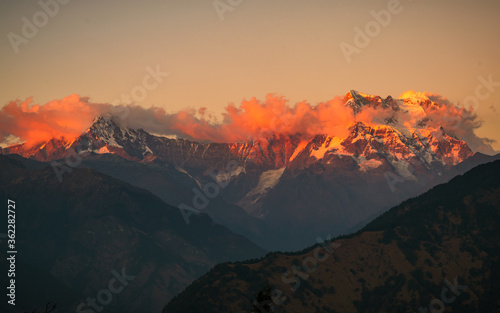 Golden sun rays falling on snow cladded Chaukambha peaks of Gangotri group of Garhwal Himalayas during sunset from Deoria Tal at Chopta, Uttarakhand, India.