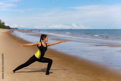 Asian woman do stretching before exercise on the beach