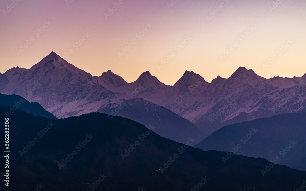 Mountain silhouette of Panchchuli peaks during morning sunrise in great Himalayan mountain chain range from Khalia Top at small hamlet Munsiyari, Kumaon region, Uttarakhand, India. Mountain silhouette of Panchchuli peaks during morning sunrise in great Himalayan mountain chain range from Khalia Top at small hamlet Munsiyari, Kumaon region, Uttarakhand, India.