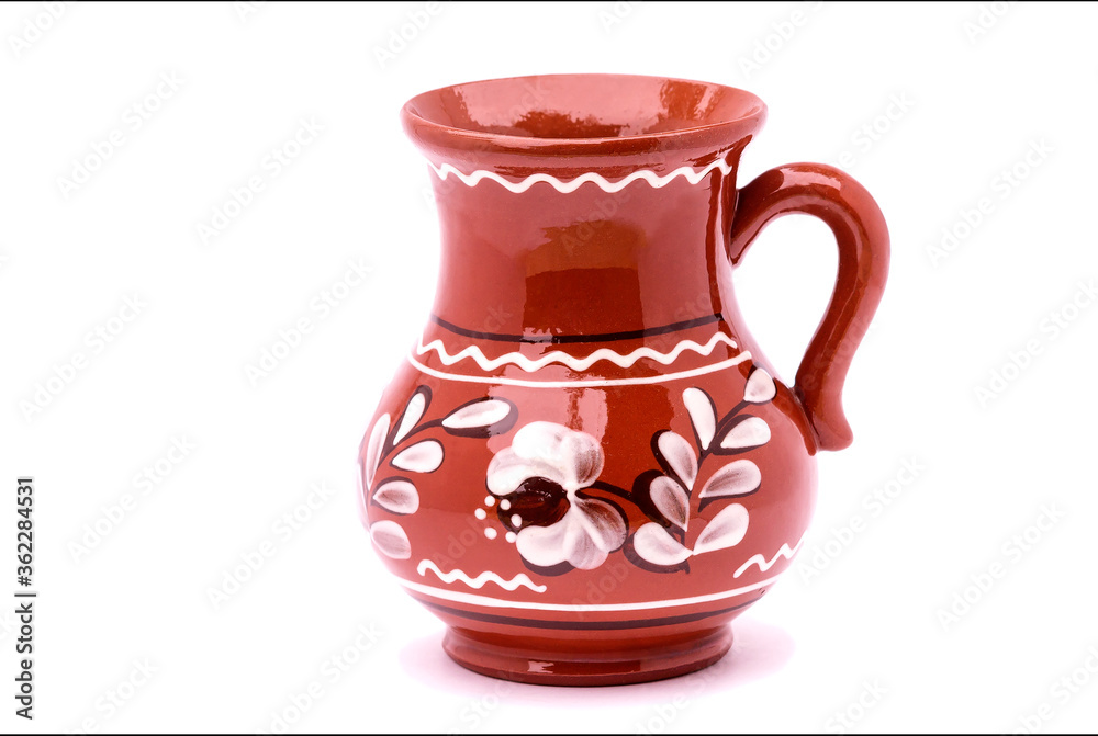 On an isolated white background, a ceramic jug with a handle for cold drinks.
