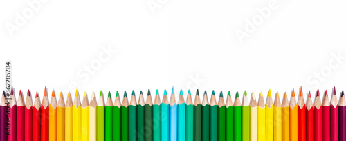 A row of multi-colored pencils isolated on a white background