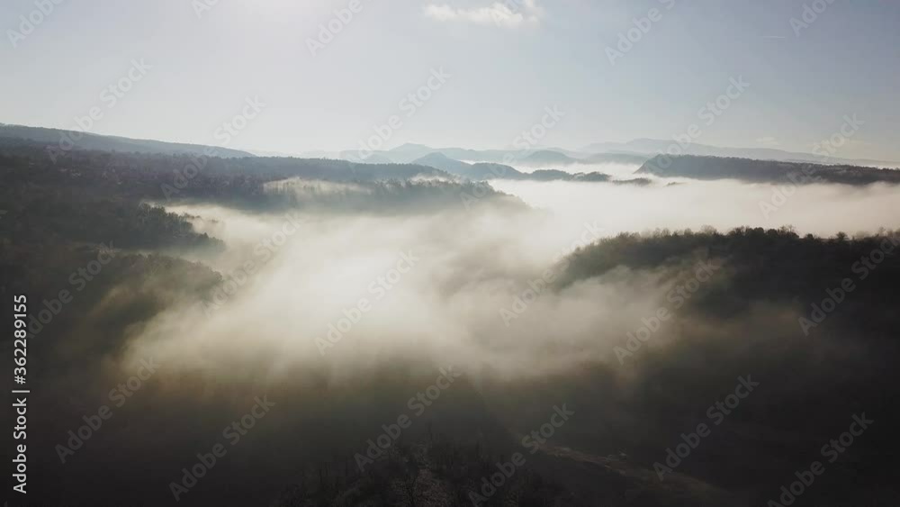 Aerial view of extensive fog covering large forest area, zooming out
Aerial view of extensive fog covering large forest area, zooming out