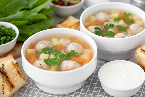 potato soup with meatballs, carrots and herbs