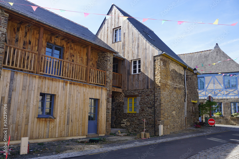 narrow street in an old town with typical stone buildings in Brittany, France