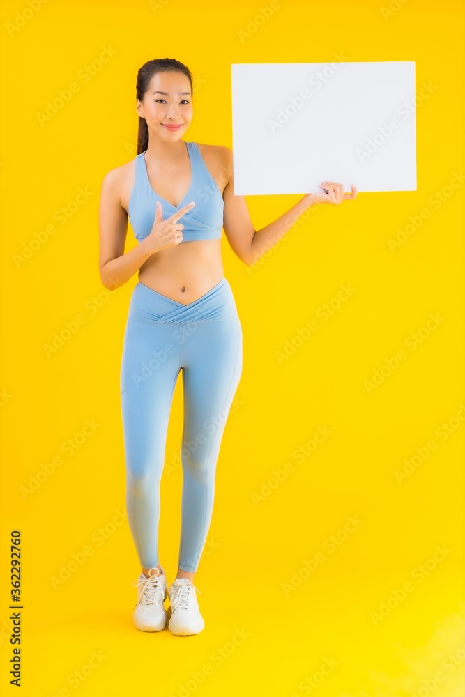 Portrait beautiful young asian woman wear sportwear show empty white billboard Portrait beautiful young asian woman wear sportwear show empty white billboard