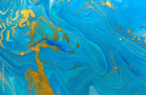 Marbled blue and gold abstract background. Liquid marble pattern.