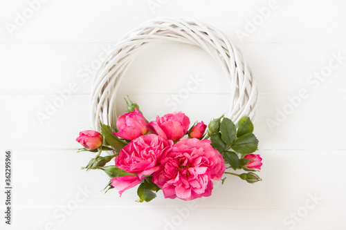 Pink Roses wreath,  flat lay, floral composition on white wooden board, empty space for  text, concept for Wedding , St. Valentine's Day, Mother's Day, Birthday, 8 march, women's day, mock up design